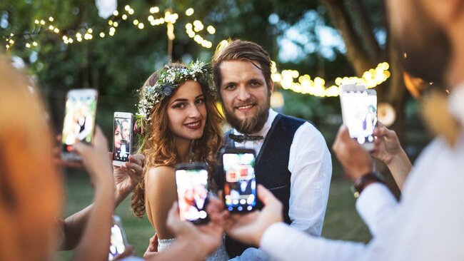 Guests-with-smartphones-taking-photo-of-bride-and-2022-02-02-03-47-53-utc